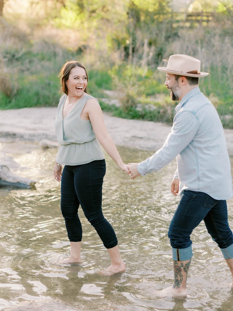 couple wading in Bull Creek for their engagement photos