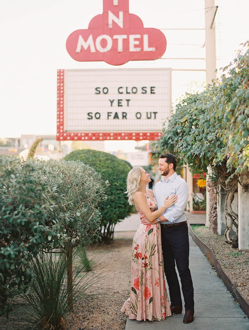 Engaged couple poses by the Austin Motel on South Congress for engagement photos