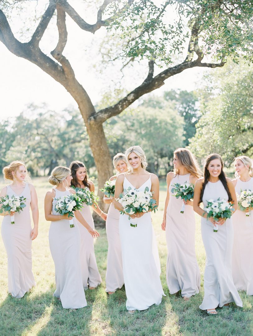 bride walking with bridesmaids captured by Austin Wedding Photographer Lucy Struve