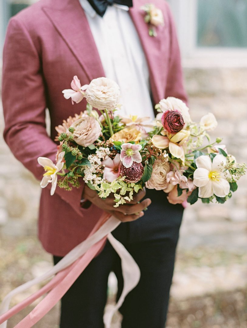 groom holding a bouquet by Austin Wedding Photographer Lucy Struve
