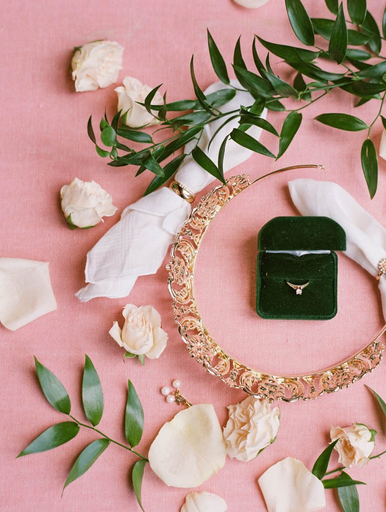 flatlay with bride's tiara and engagement ring