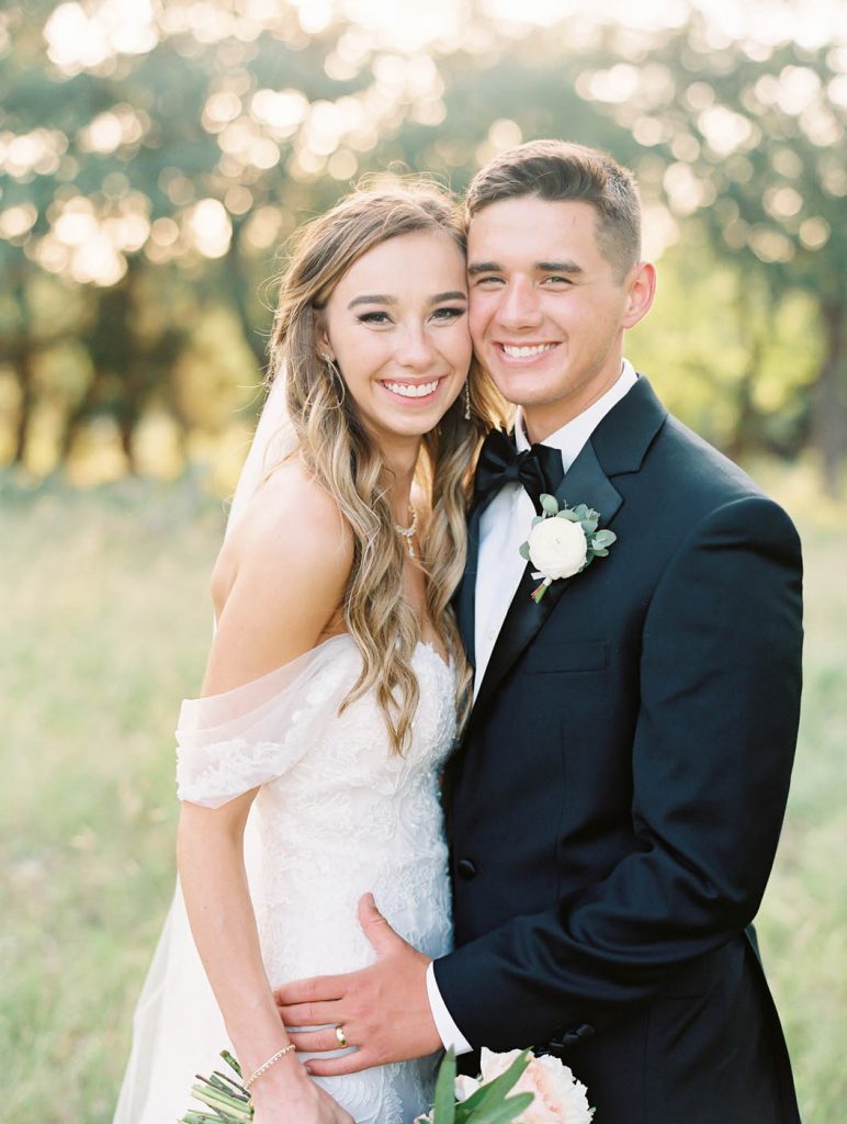 a classic portrait of the bride and groom smiling