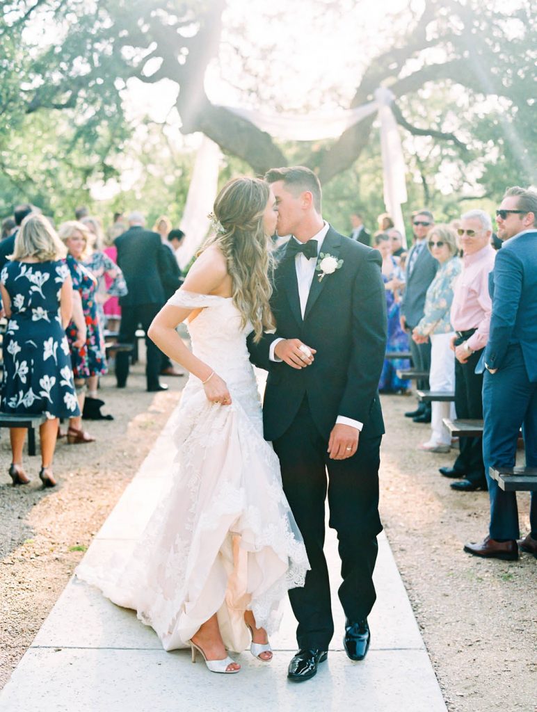 the bride and groom kiss at the end of the recessional