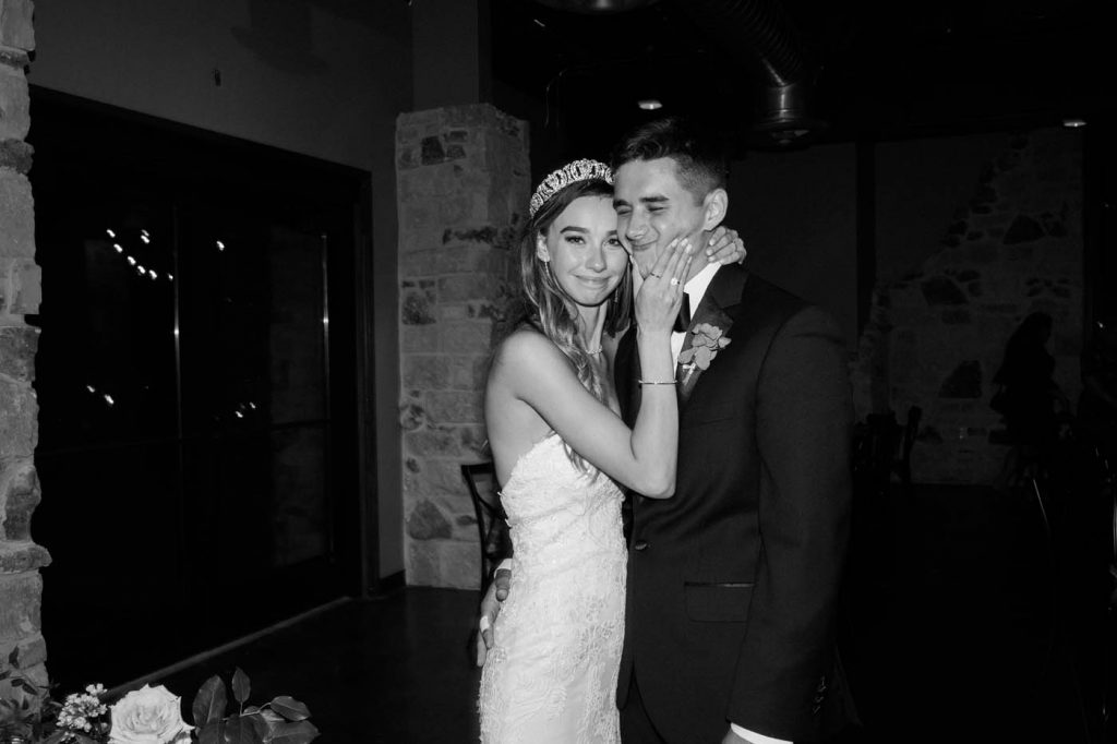 the bride pinching the groom's cheeks