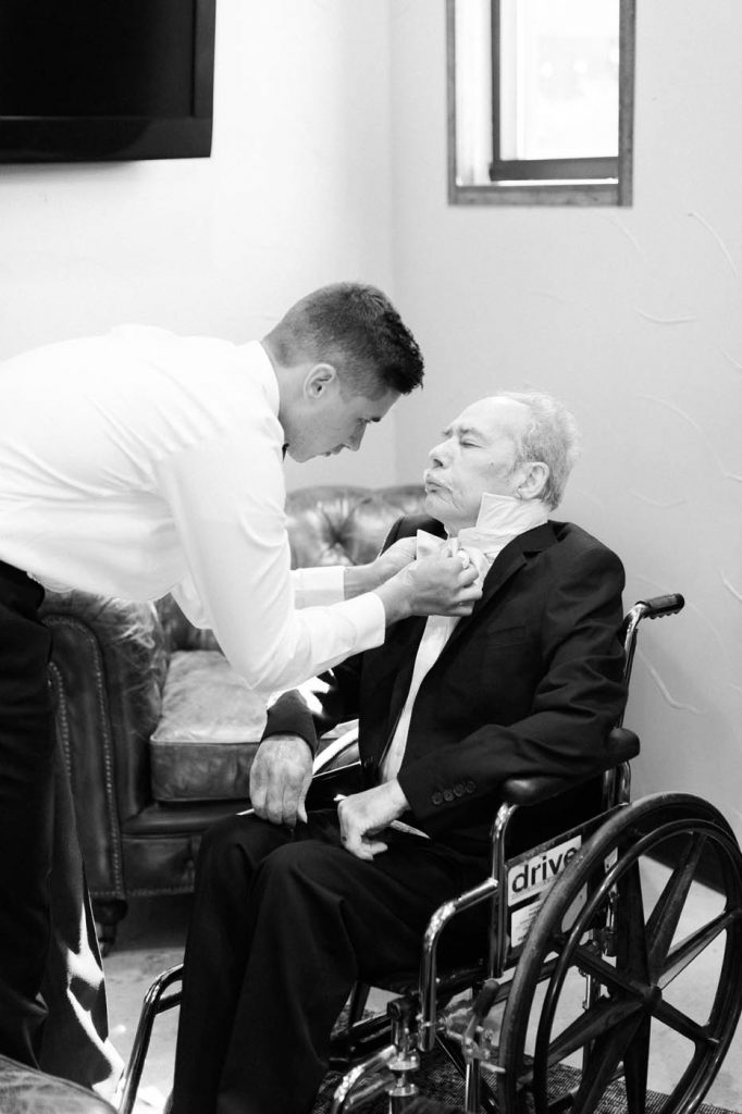 the groom helps his grandfather get ready for the wedding