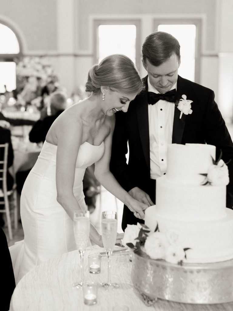 The bride and groom cut their cake together