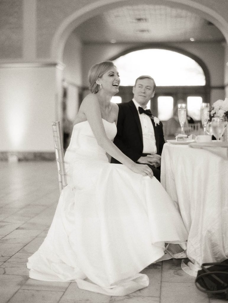 The bride laughs during a speech