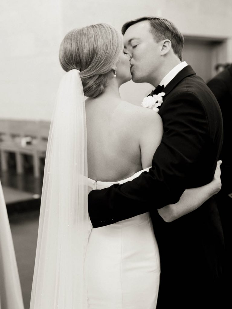 the bride and groom kiss after the ceremony