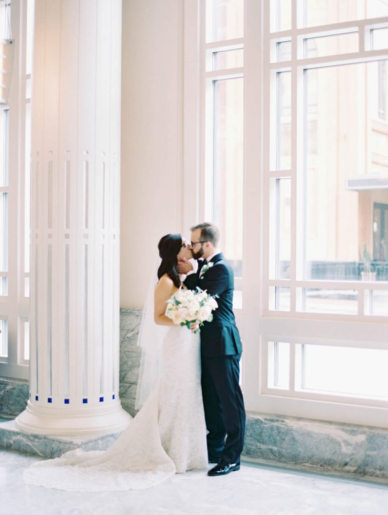 Bride and groom kiss at Bass Hall