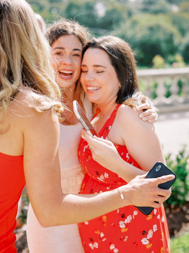 The bride hugs her friends excitedly
