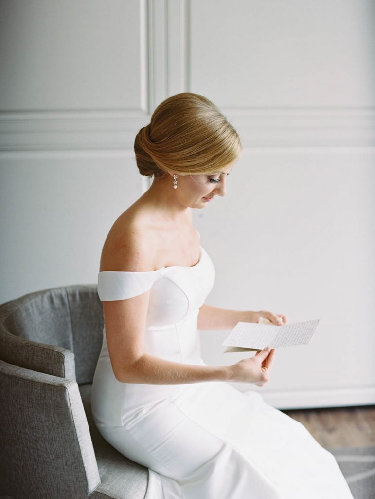 the bride reads a letter from the groom at the Worthington Renaissance in Fort Worth
