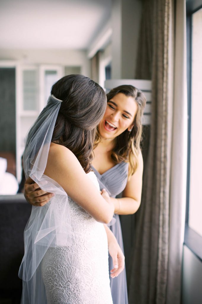 Bride and sister share a moment together
