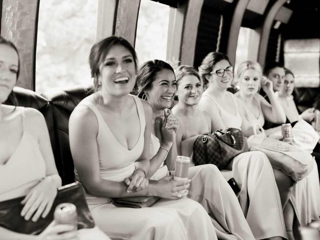 a bridesmaid laughs on the way to the reception