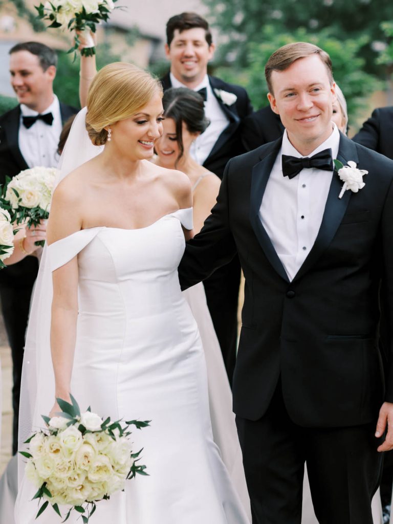the bride and groom smile together