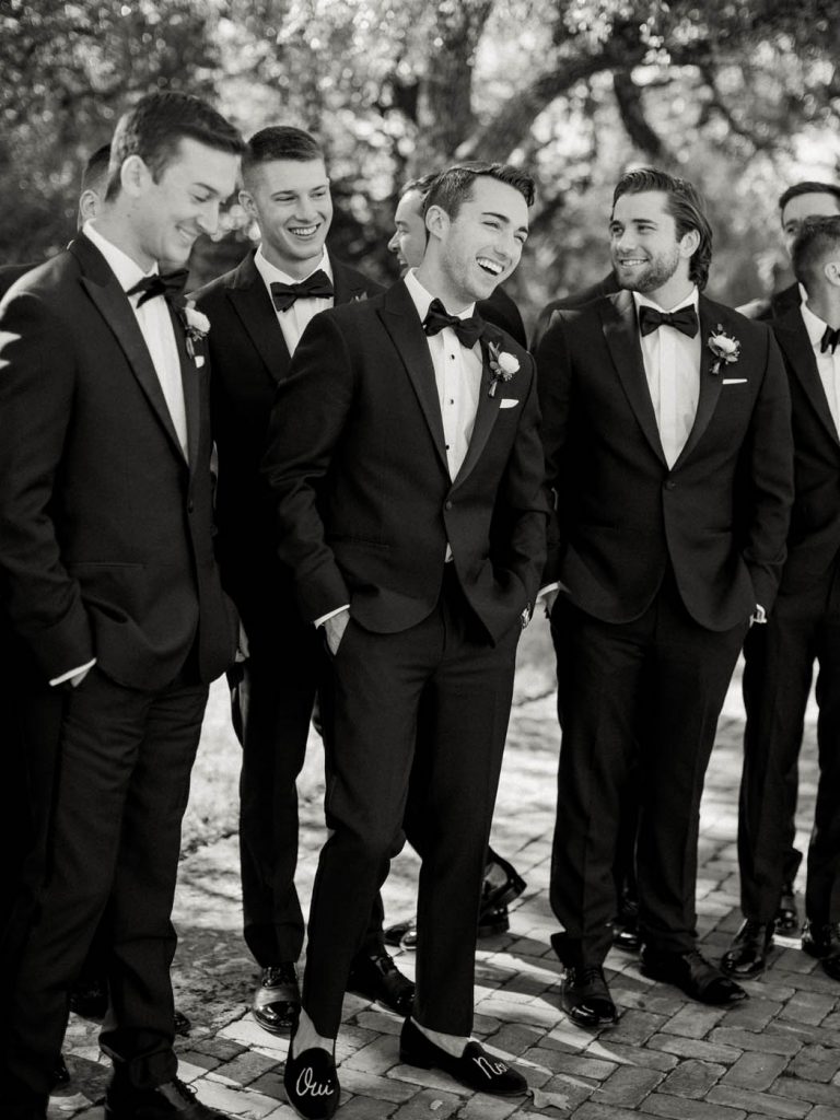 The groom poses naturally for the camera with his groomsmen