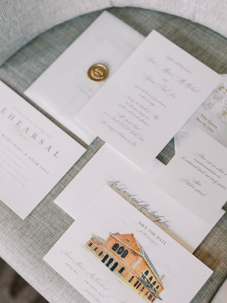 wedding invitation flatlay with custom venue illustration