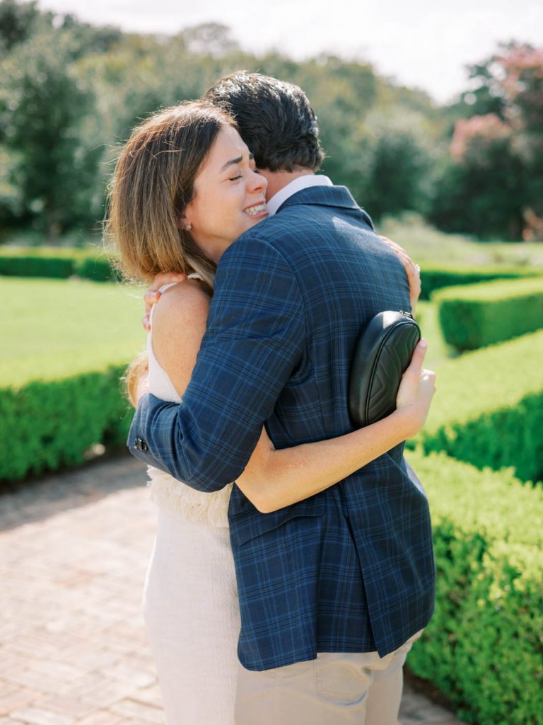 The couple hugs after becoming engaged