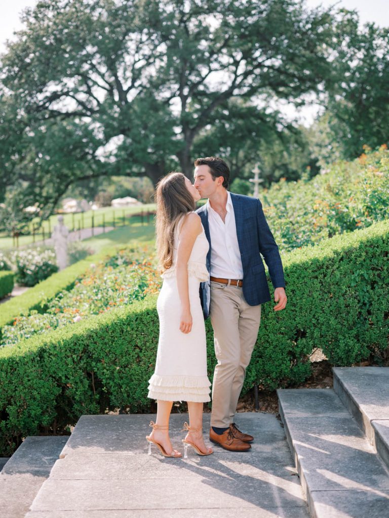 The couple kisses on the stairs of the Commodore Perry