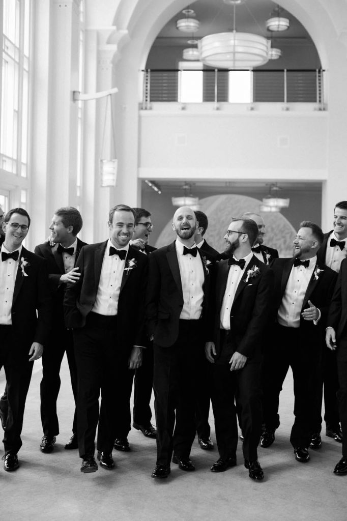 Groomsmen in black and white walking together