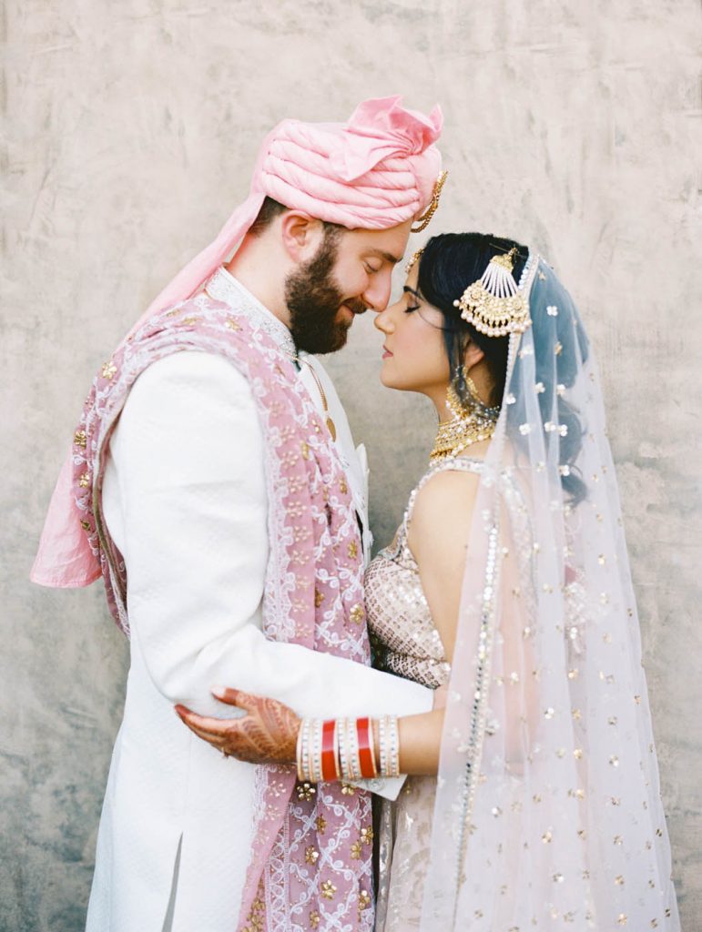 The indian bride and groom pose together