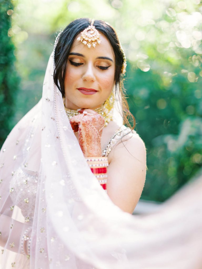 The bride poses with her draping ghoonghat