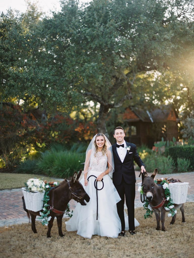 The bride and groom pose with beer burros