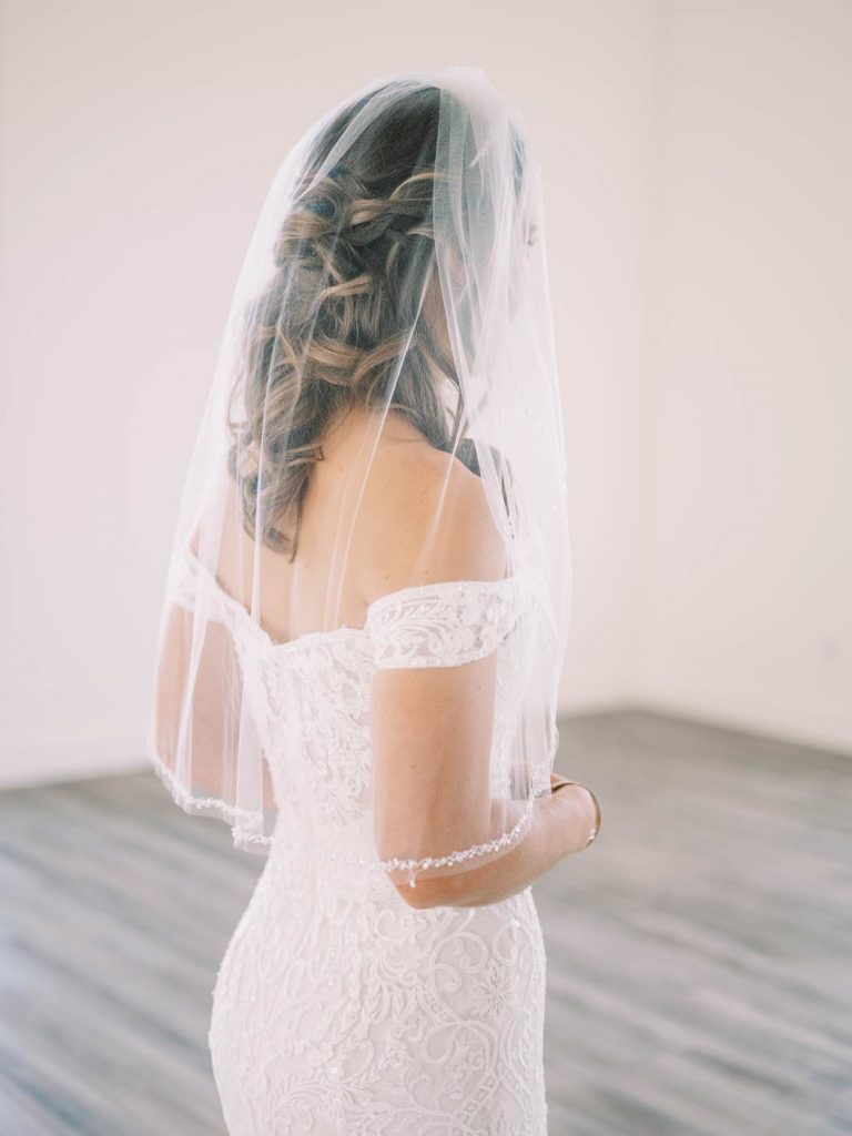 bride back of dress with veil on