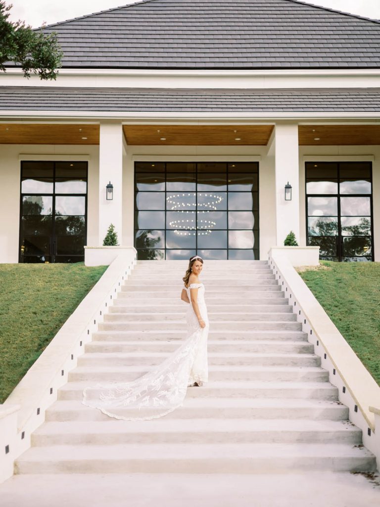 bride on stairs holding her dress