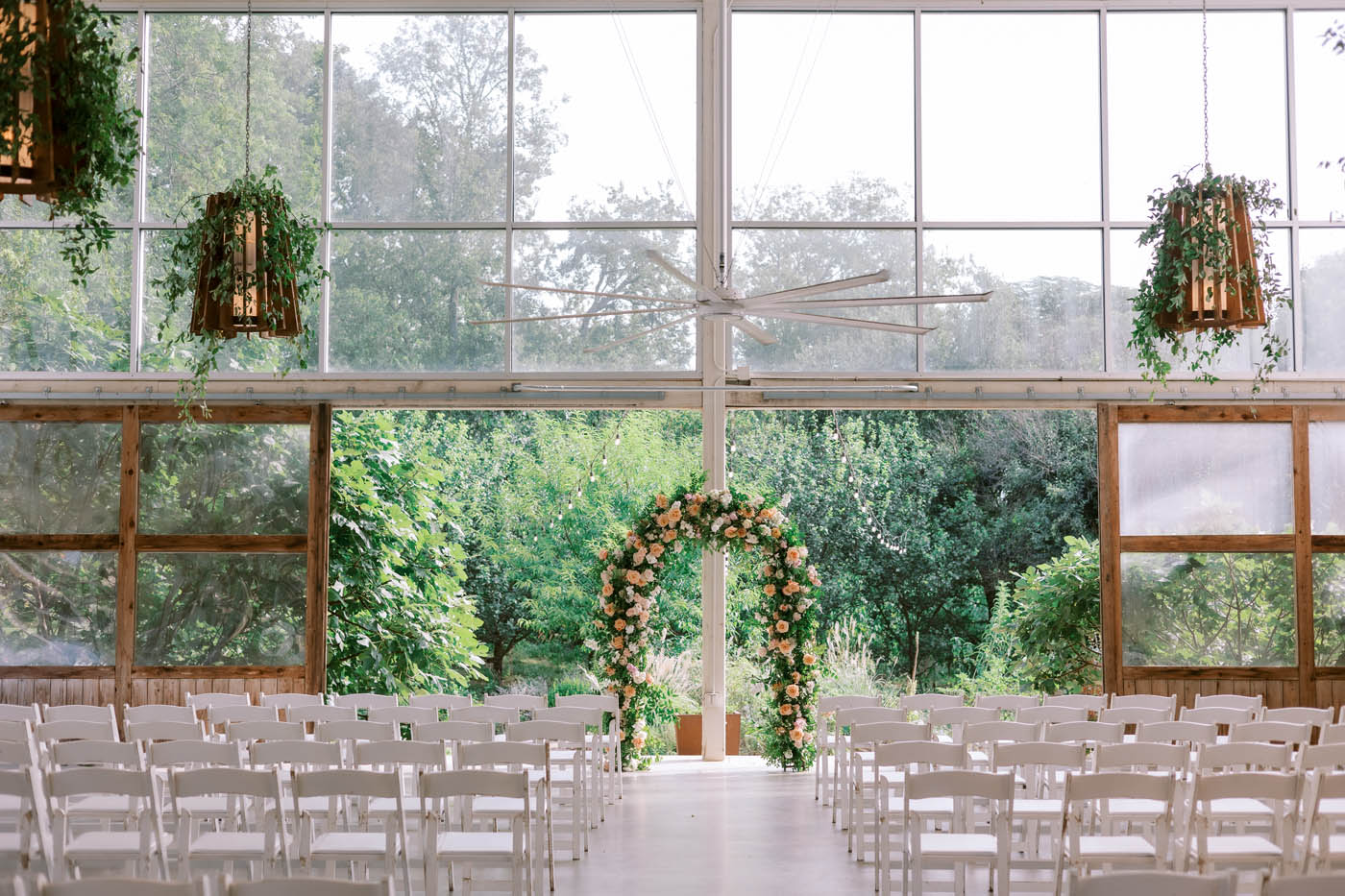 barr mansion ceremony setup with floral arch