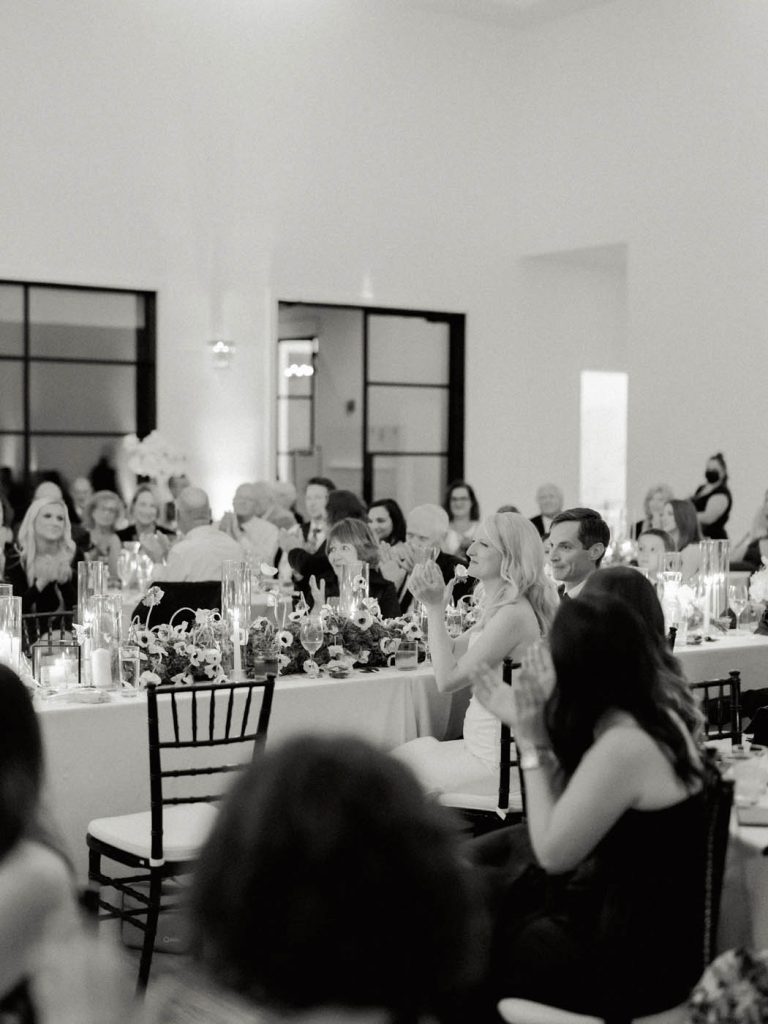 bride and groom applaud during toasts