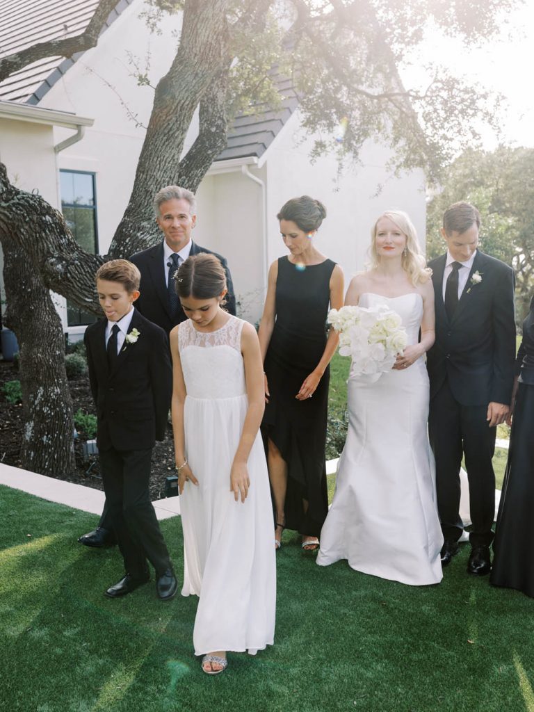candid image of the flower girl between family photos