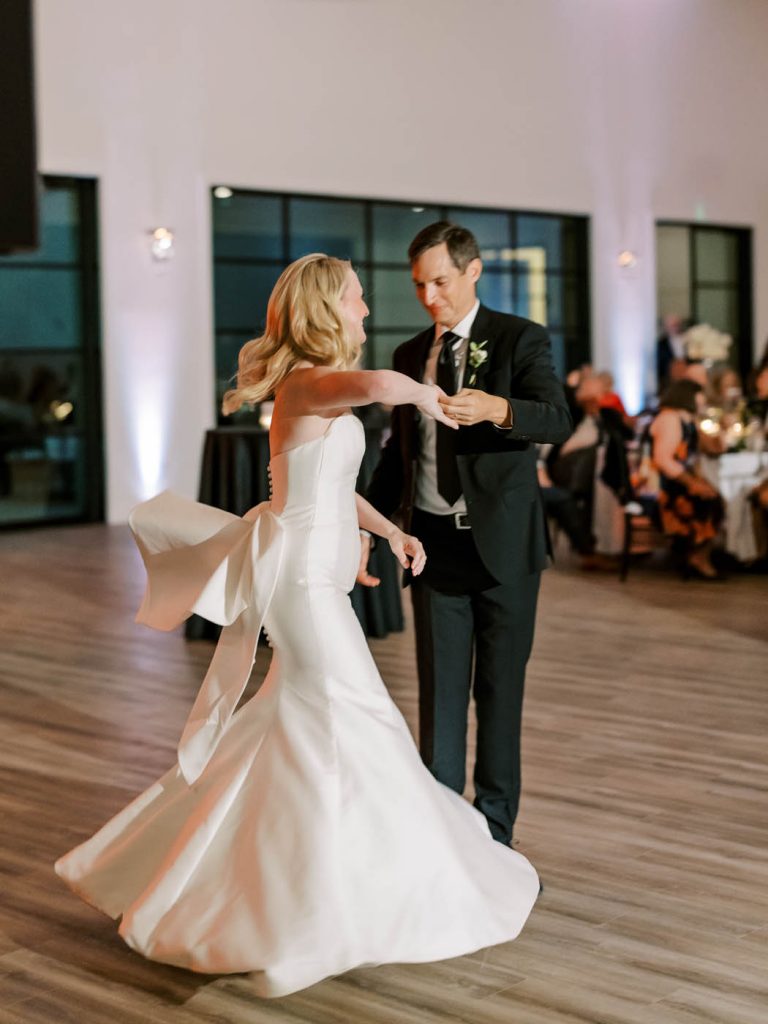 bride and groom spin during their first dance
