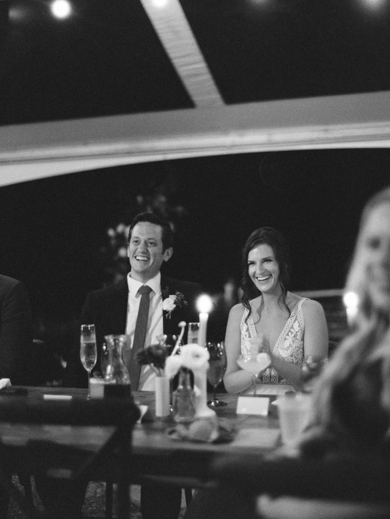 the bride laughing during the wedding speeches
