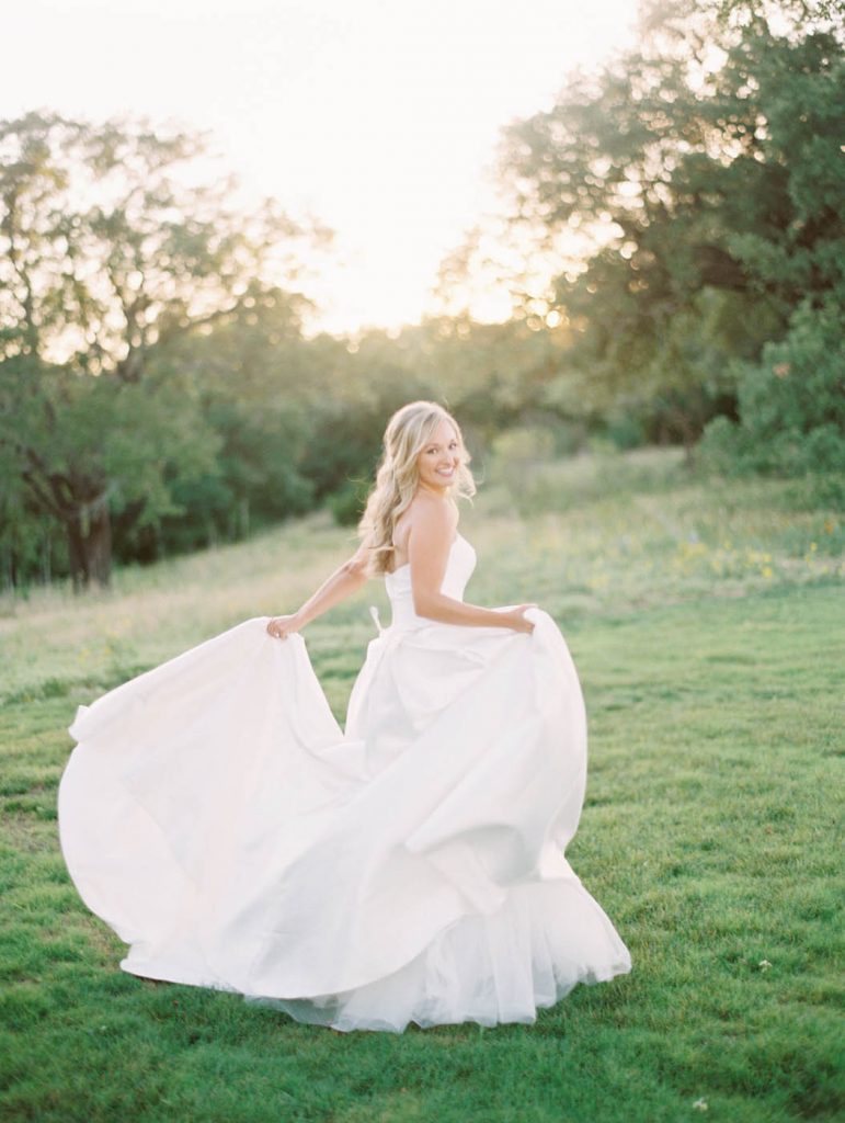bride playfully runs away with her skirt in her hands