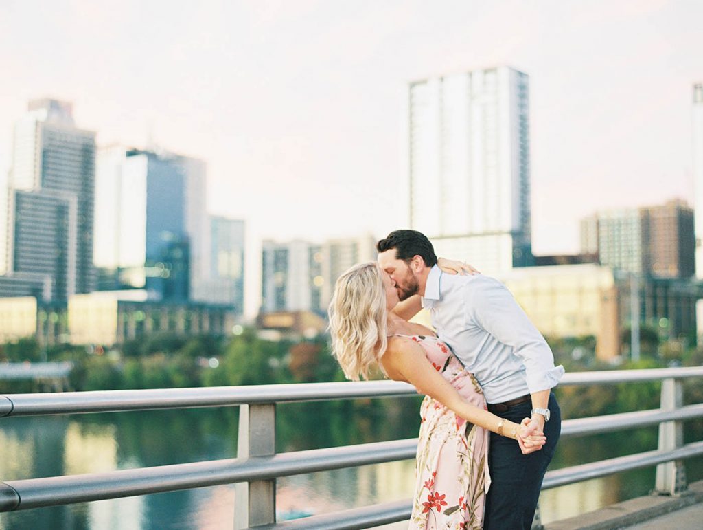 couple kissing on the south congress bridge