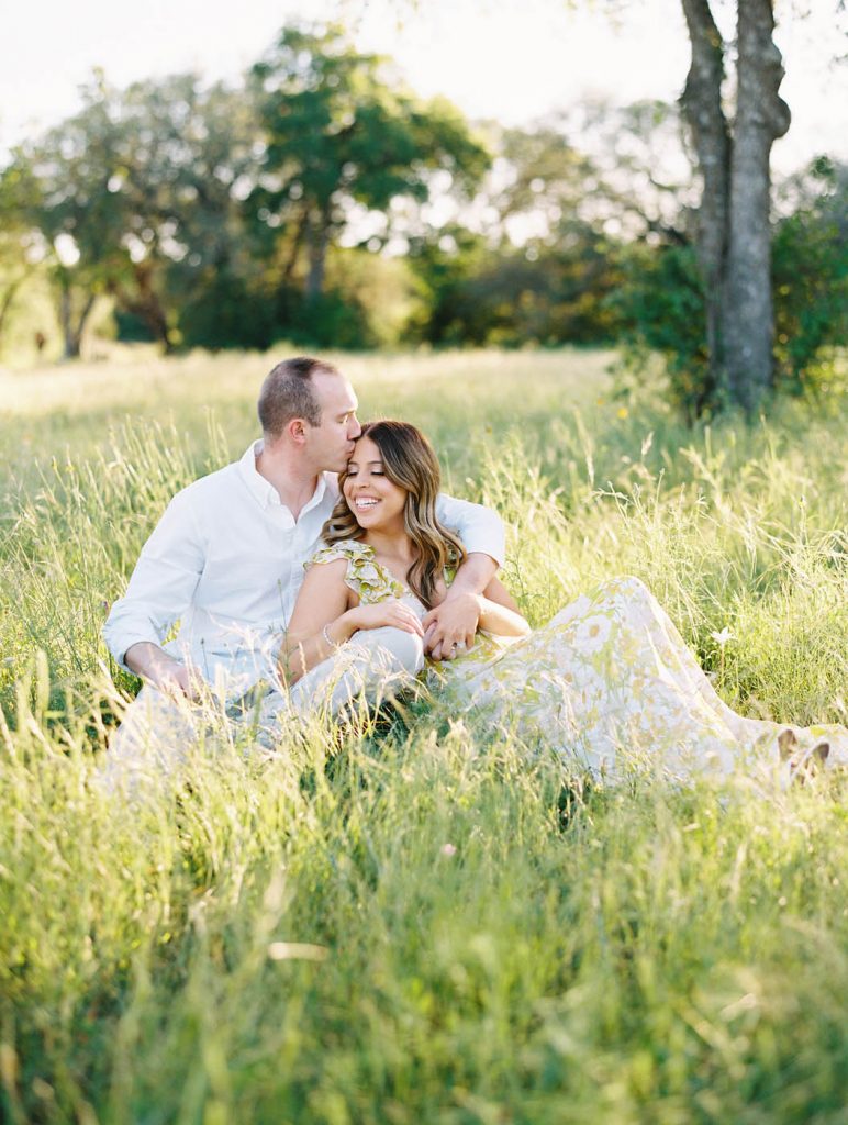 couple sitting in tall grass in south austin