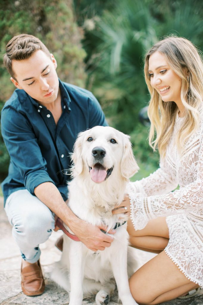 couple posing with their dog at their engagement session