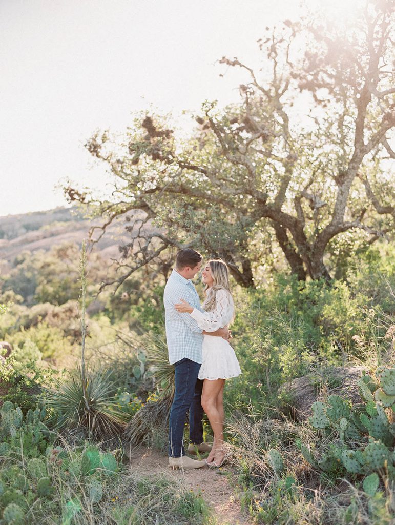 engagement photo of a couple at enchanted rock in fredericksburg