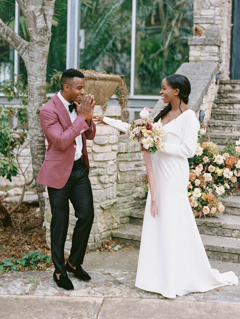man in pink jacket gasps as he sees his bride