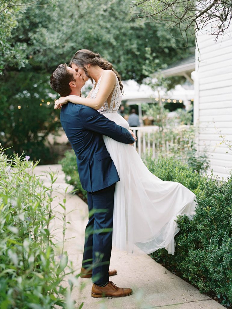the groom picks up the bride for a kiss