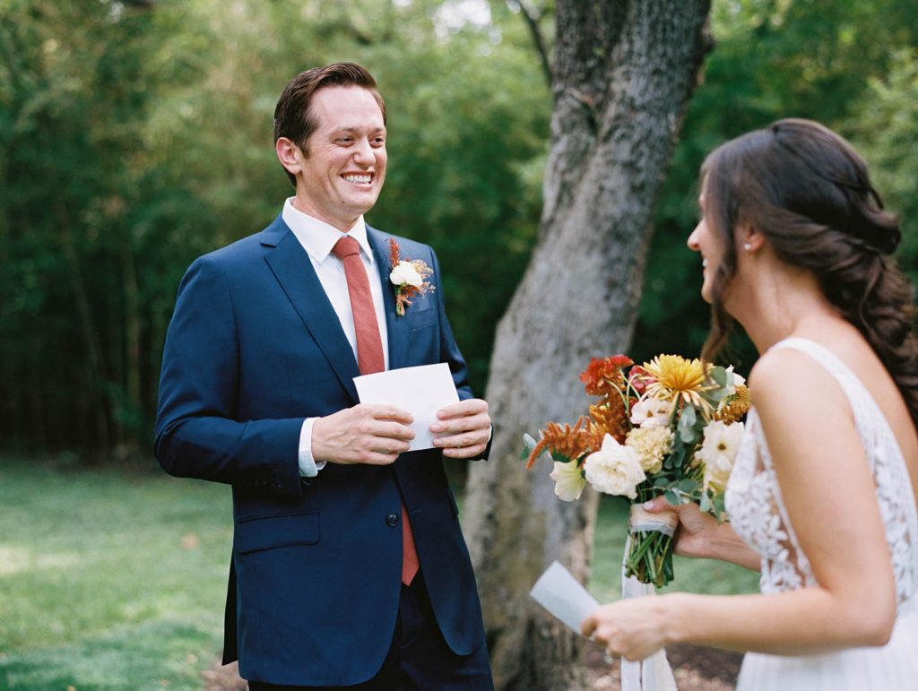 the groom laughs after reading the letter from the bride