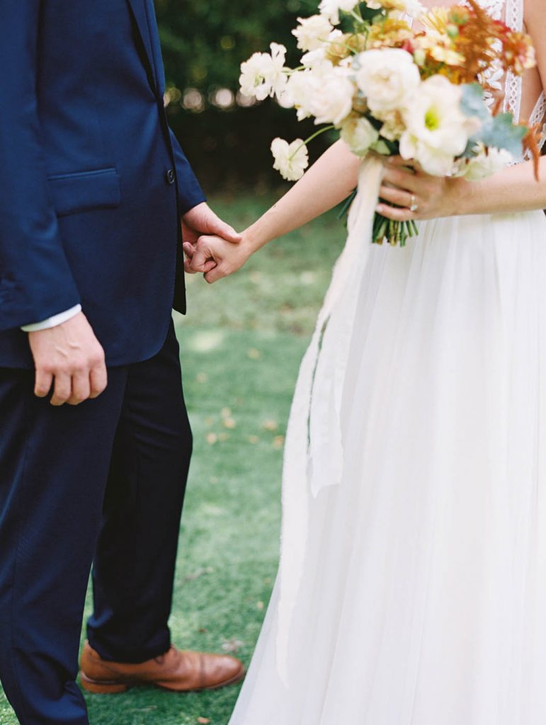 the couple holds hands after seeing each other for the first time