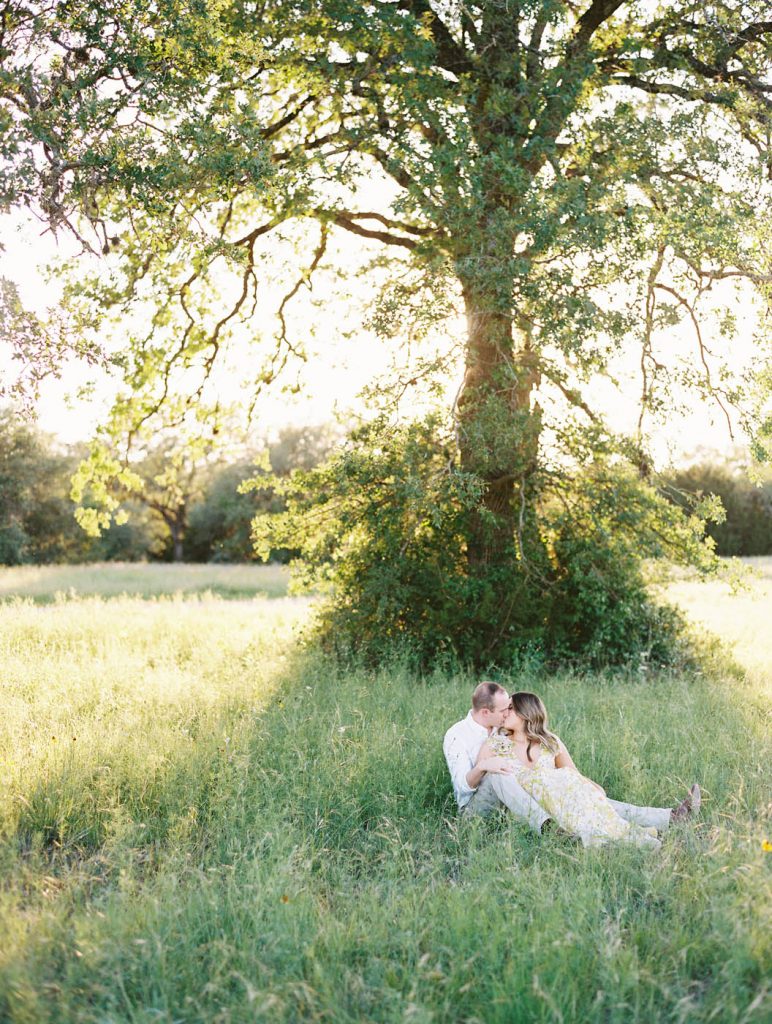 couple sitting under an oak tree at Circle C Park in Austin