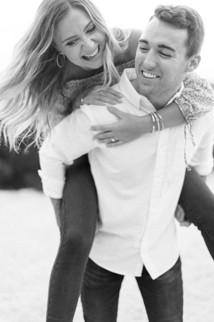 piggy back ride in black and white engagement photo