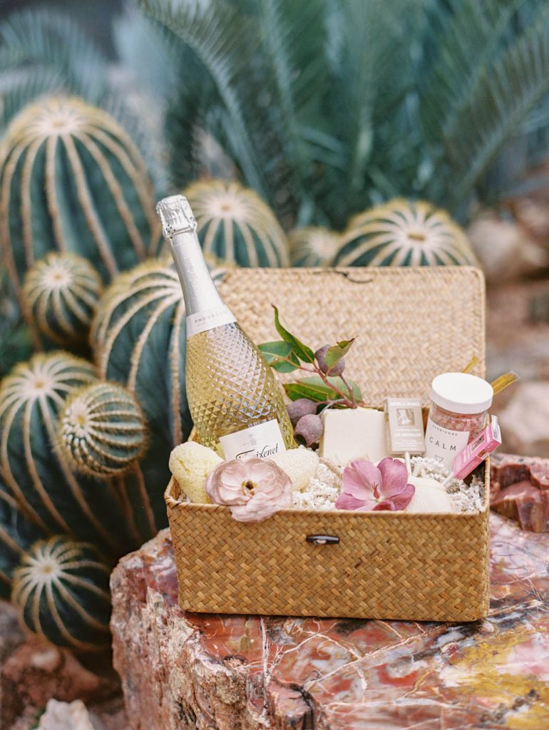 a wedding welcome basket styled next to a cactus