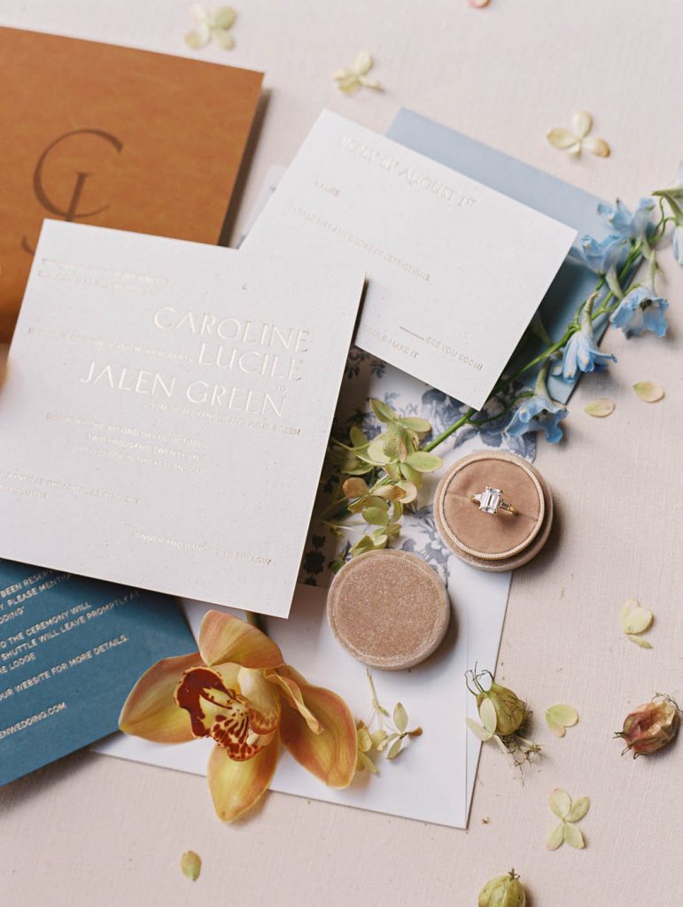 modern wedding invitation flatlay with engagement ring by J Brooks Jewelers