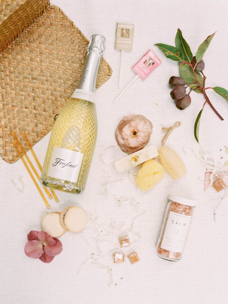 a romantic flatlay of the contents of the wedding welcome basket