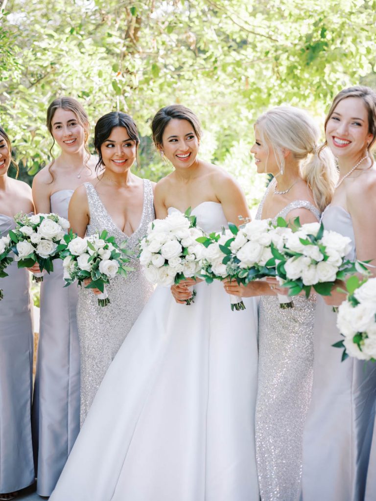 the bride smiles at her bridesmaids