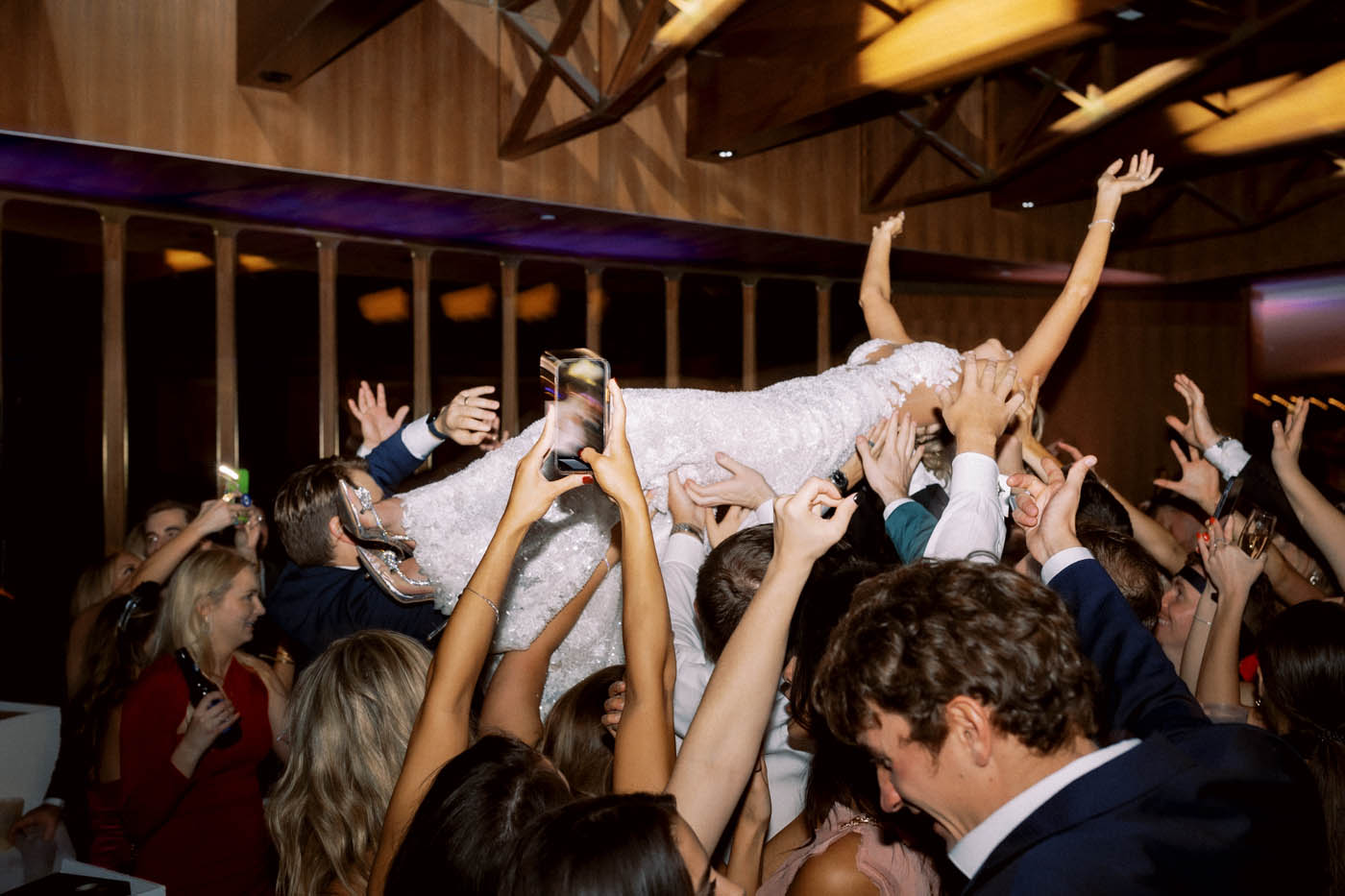 the bride crowdsurfs in her Ines Disanto gown