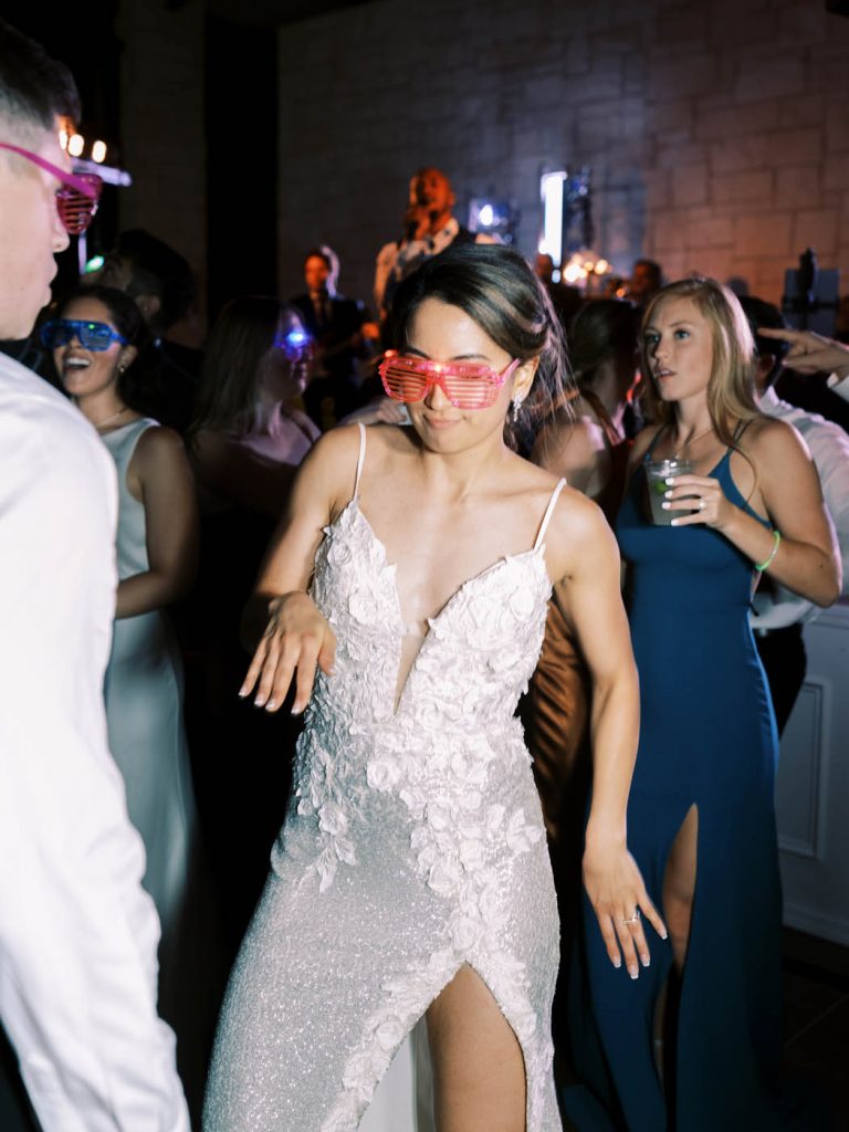 bride dancing with toy sunglasses